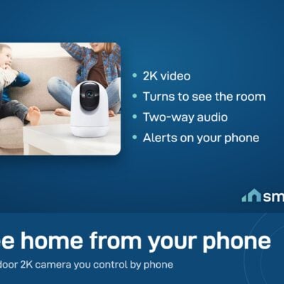 CloudEdge Pan and Tilt Camera on a table in a living room with two children playing on the sofa
