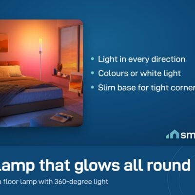Govee Cylinder Floor Lamp glowing beside a bed in an orange bedroom