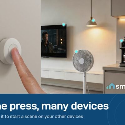 Finger pressing a Sonoff SNZB-01P wireless button on a wall, in a room with a fan and a coffee machine. Needs a Zigbee hub