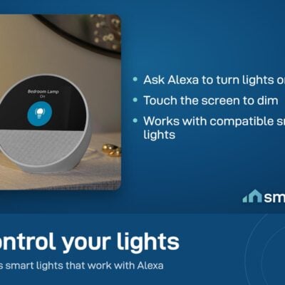 Amazon Echo Spot beside a bedside lamp, its screen showing Bedroom Lamp on; ask Alexa or touch to dim compatible lights