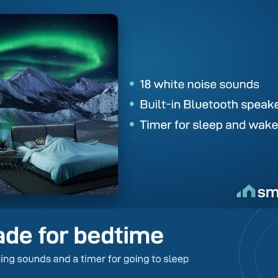 Govee Star Light Projector on a bedside table with green aurora over a bed; 18 white noise sounds and a Bluetooth speaker