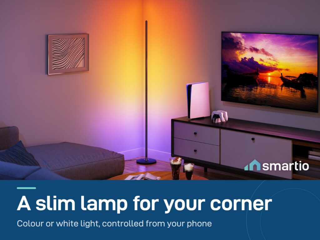 Govee Floor Lamp Basic standing in a room corner beside a TV, glowing orange and purple