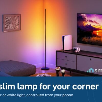 Govee Floor Lamp Basic standing in a room corner beside a TV, glowing orange and purple