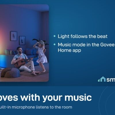 A father plays guitar and his daughter dances in a room lit by two Govee Floor Lamp Basic lamps in music mode