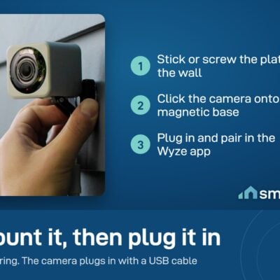 A hand fitting the Wyze Cam v4 onto its magnetic mount on an outside wall