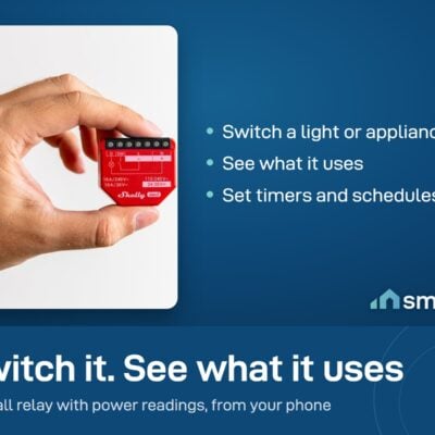 Shelly 1PM Gen3 relay held in a hand, a small relay that switches a load and measures its power use