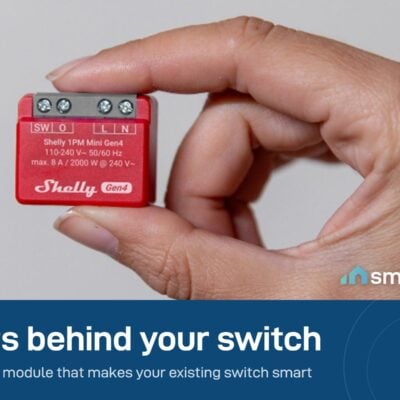 Shelly 1PM Mini Gen4 held between two fingers