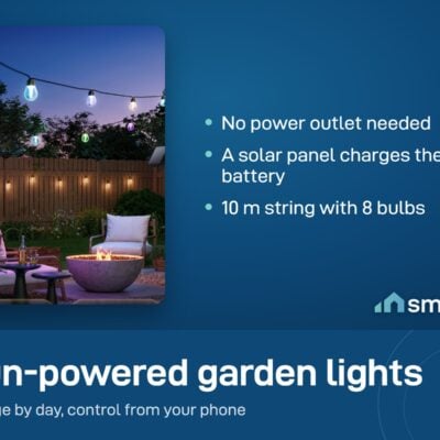 Govee Outdoor Solar String Lights hung over a garden patio at night, powered by a solar panel
